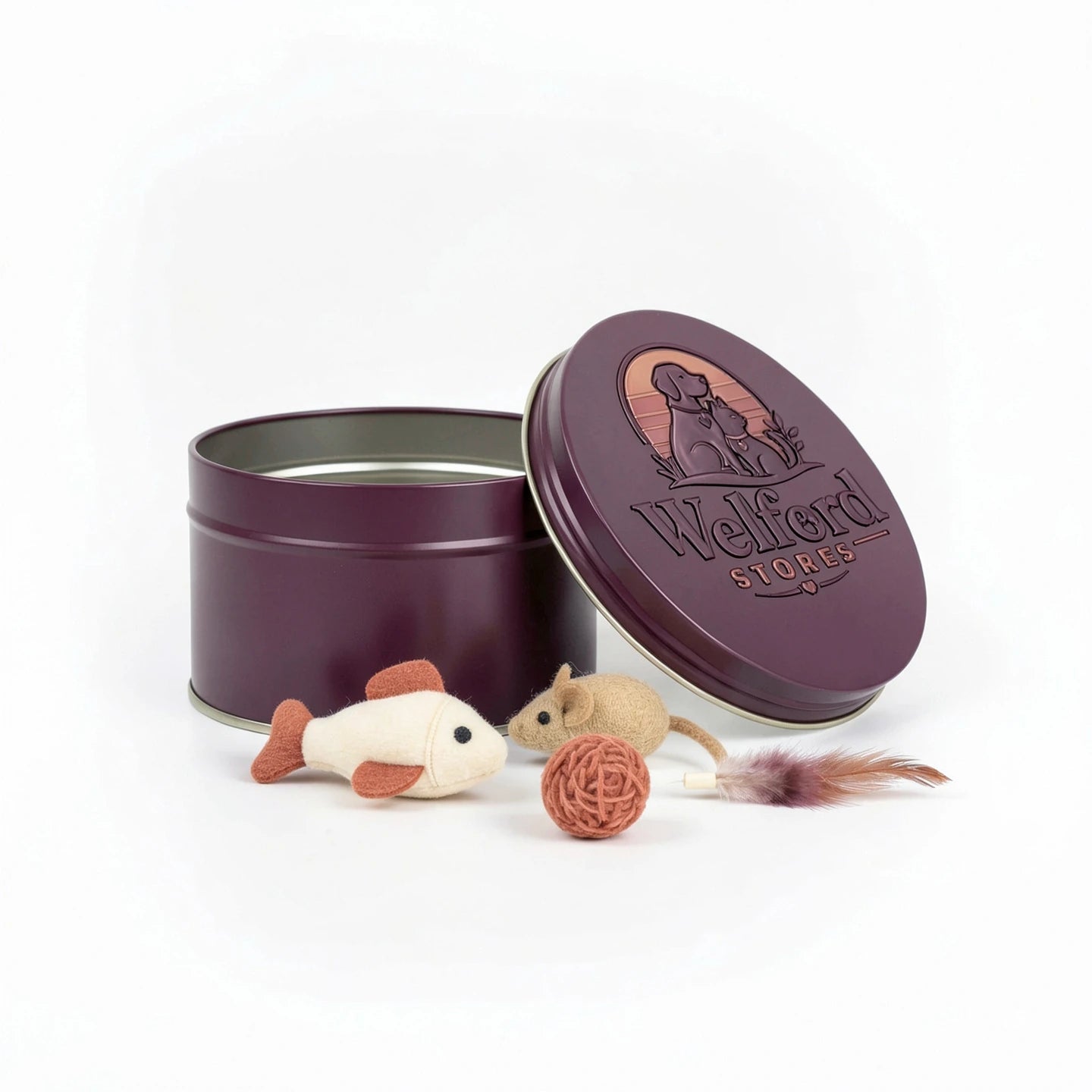 Open plum Welford Encore tin for cats with felt fish, felt mouse, woven ball and feather lure on a white background