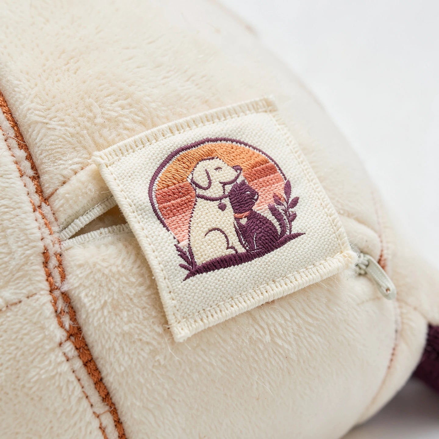 Macro detail of the woven emblem patch stitched to the Welford Vault catnip kicker